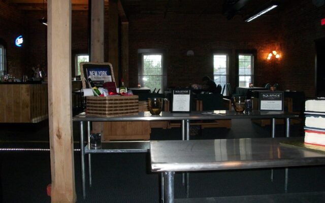 Tables are staged and feature a prize basket for a business event at Chameleon.